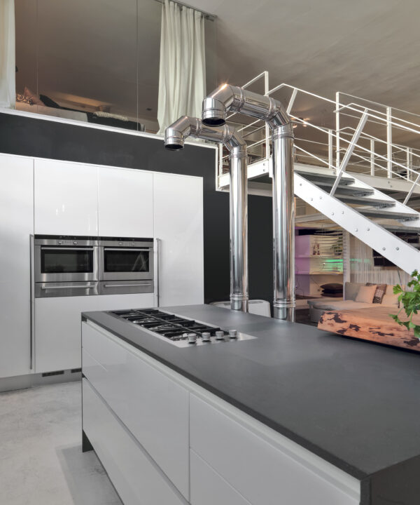 interior view of a modern kitchen in the loft with iron staircase