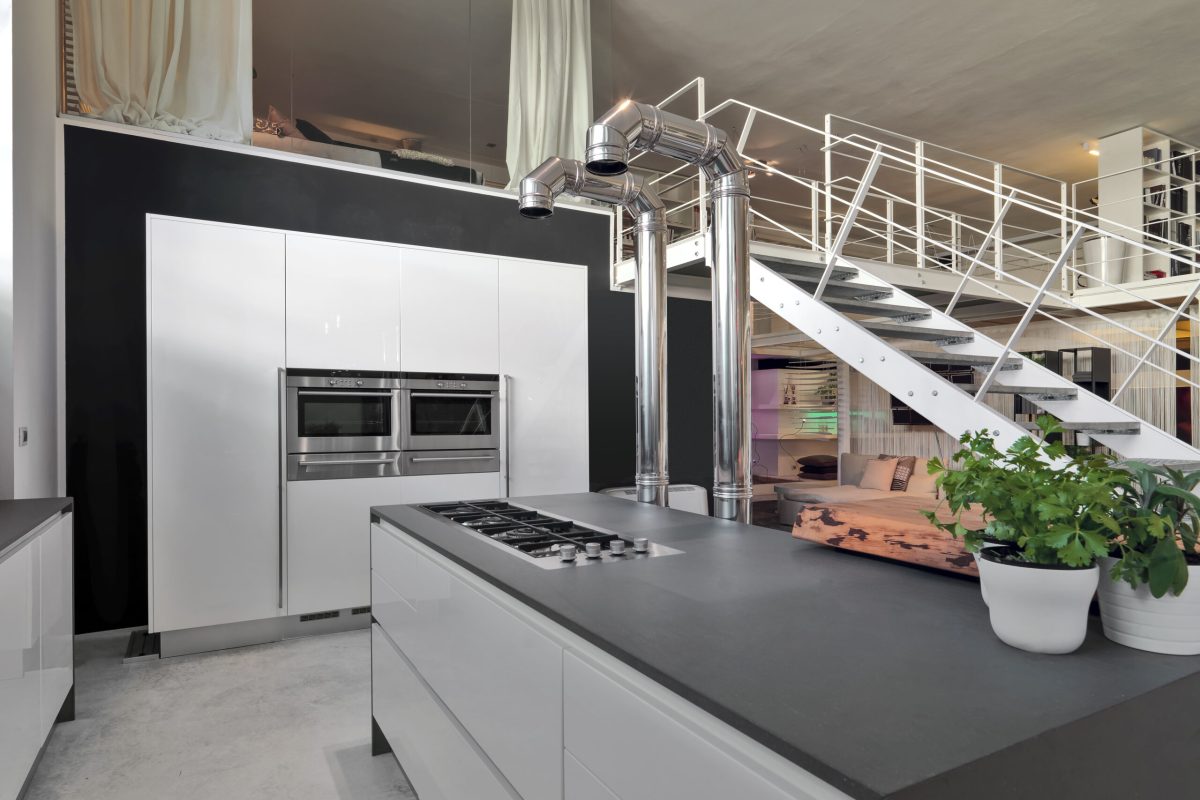 interior view of a modern kitchen in the loft with iron staircase